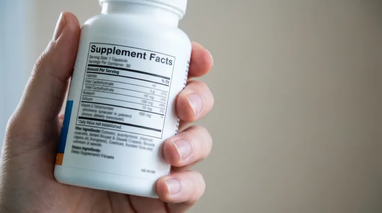 Close-up of a supplement bottle turned to show the Supplement Facts panel and ingredient list